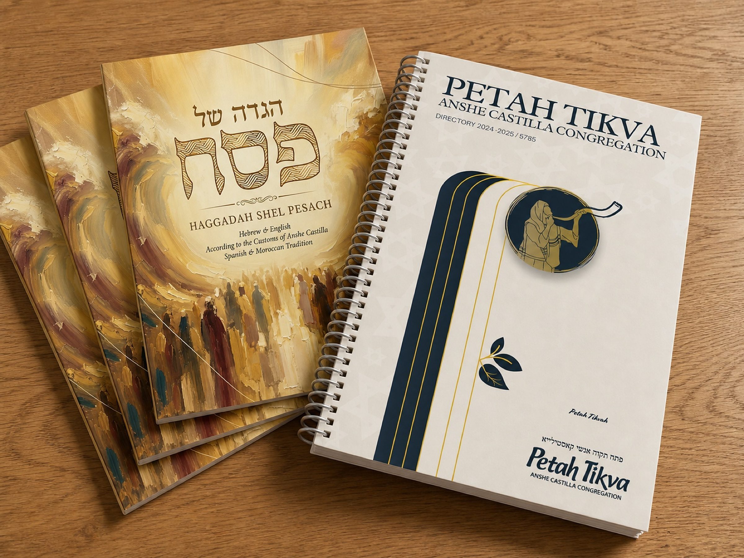 Three Haggadahs and the directory, fresh off the press and fanned out on the table.